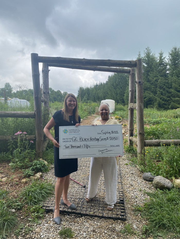 Dorothy Abbot from the Grey County Black Heritage Society being presented a check for 2050 dollars by Jennifer