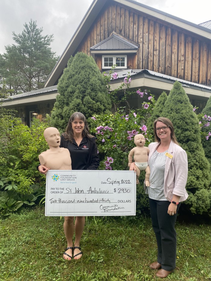 Check for 2930 dollars presented by Christine to Kathy Ermel from St. John Ambulance