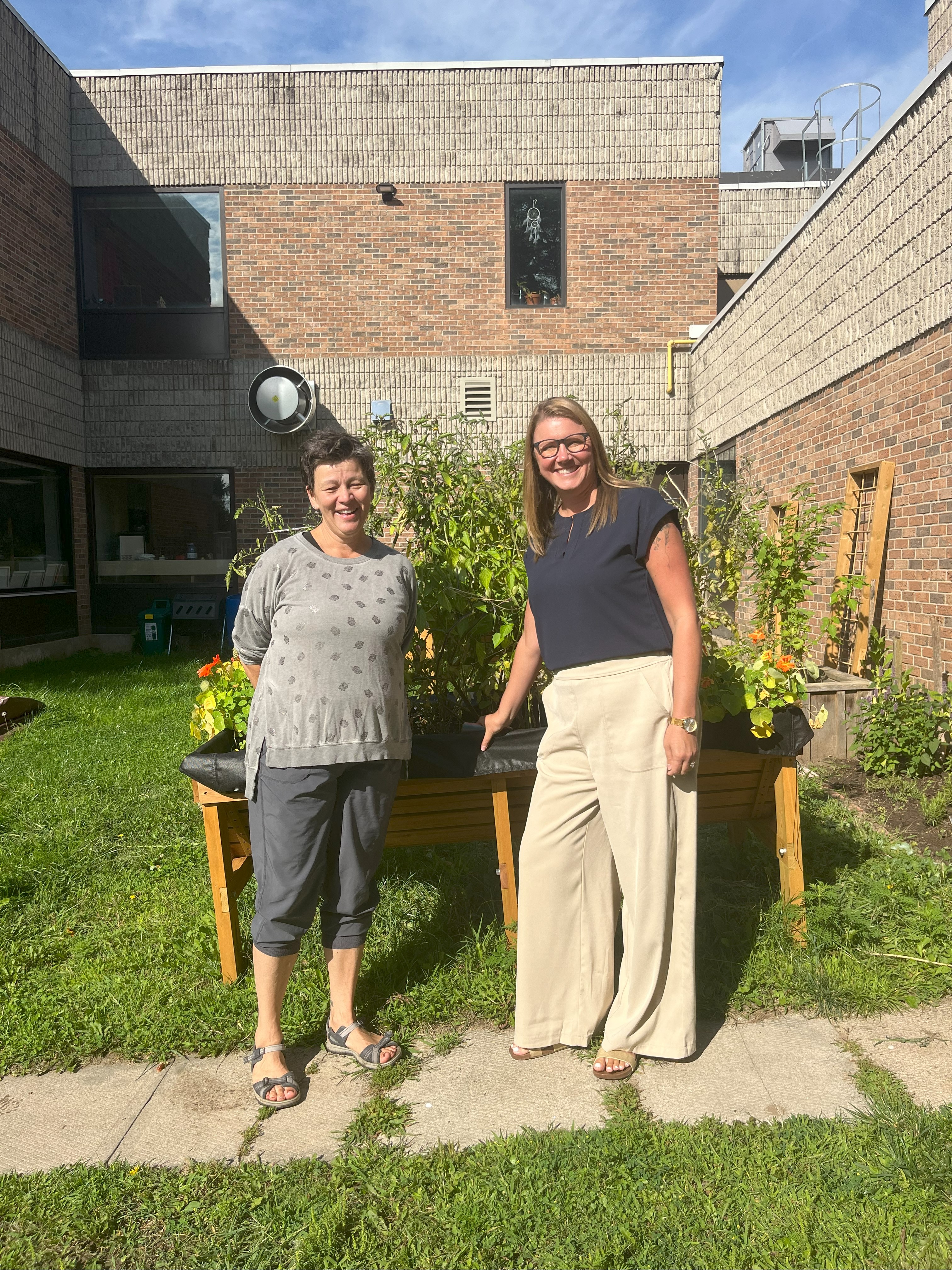 M'Wikwedong and Community Foundation Grey Bruce staff pose in front of the new M'Wikwedong Teaching Garden, located in Owen Sound. 